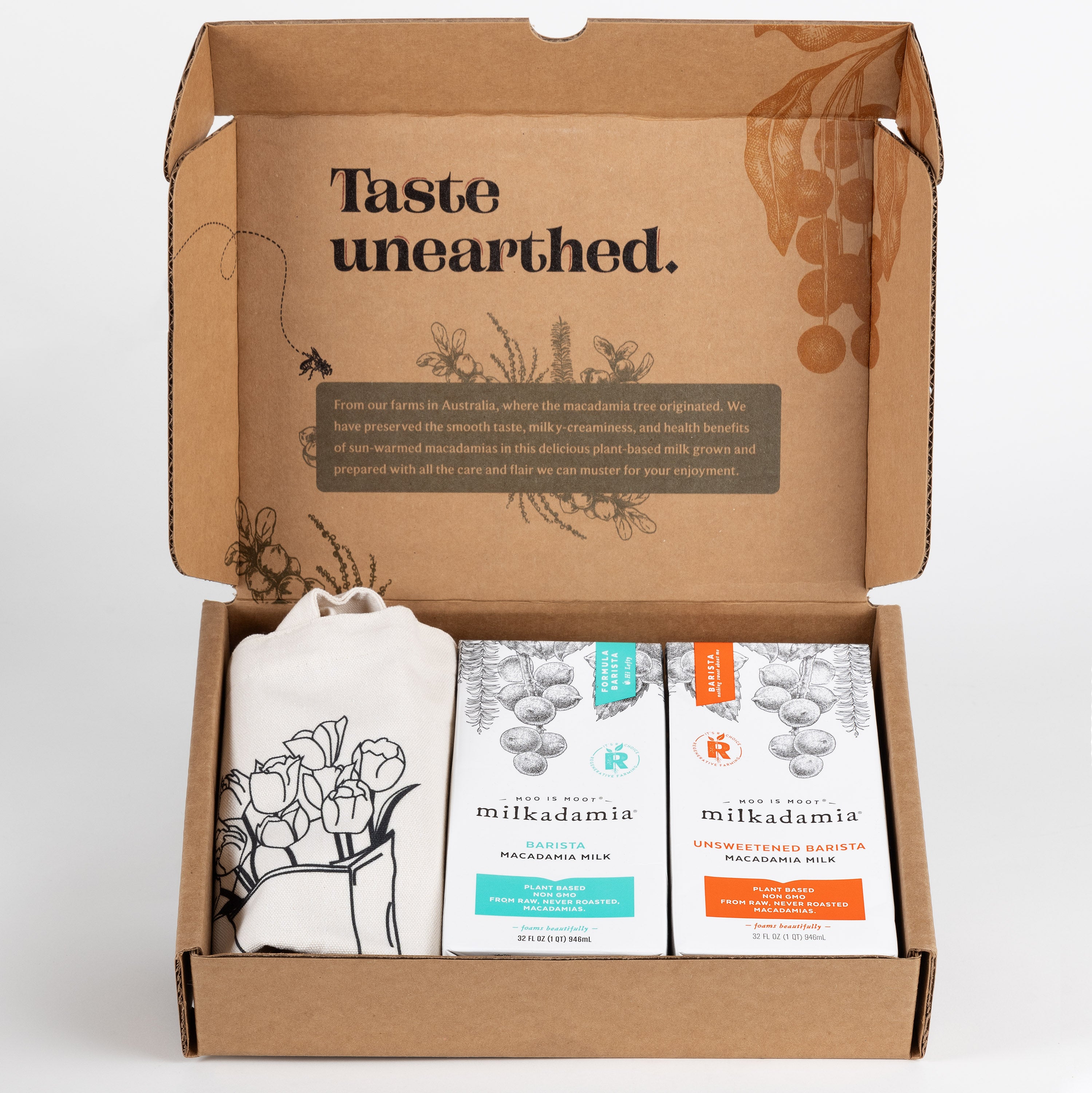 Milkadamia Barista Blend holiday gift box containing two individual 32 oz cartons of Milkadamia Barista and Unsweetened Barista and a signature Milkadamia tote bag