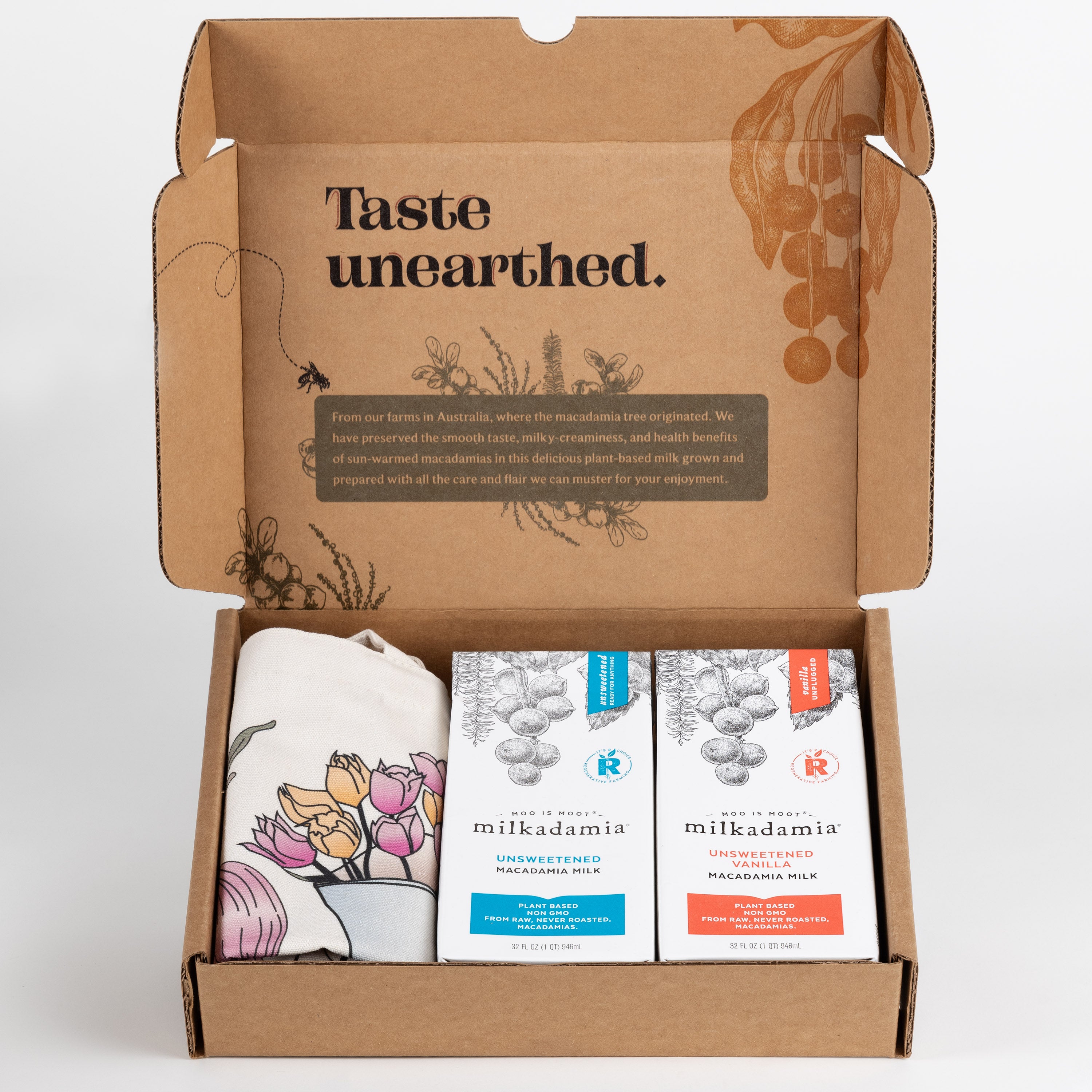 Milkadamia unsweet holiday gift box containing two individual 32 oz cartons of Milkadamia Unsweetened and Unsweetened Vanilla and a signature Milkadamia tote bag