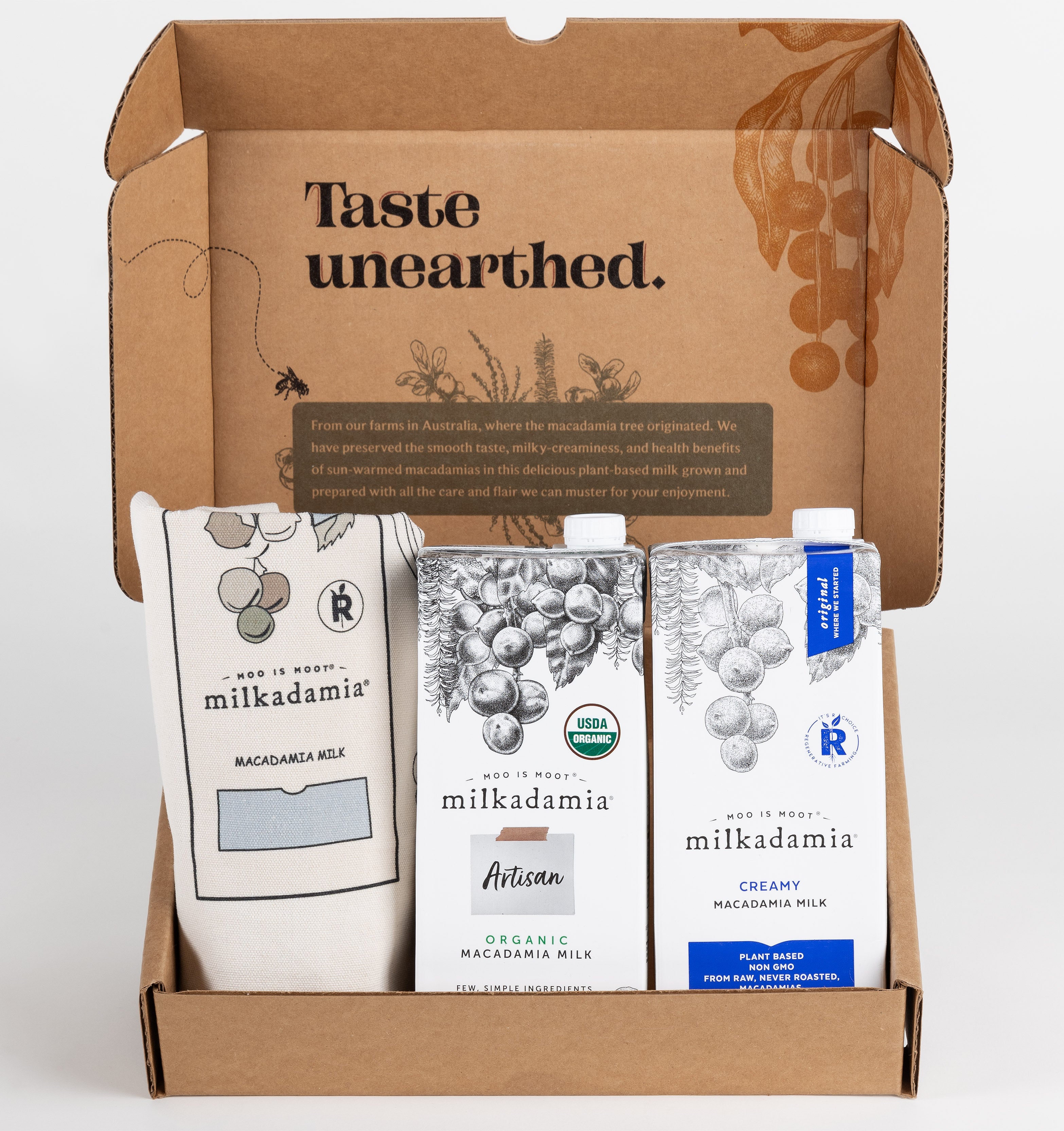Milkadamia sweet holiday gift box containing two individual 32 oz cartons of Milkadamia Creamy and Organic Artisan and a signature Milkadamia tote bag