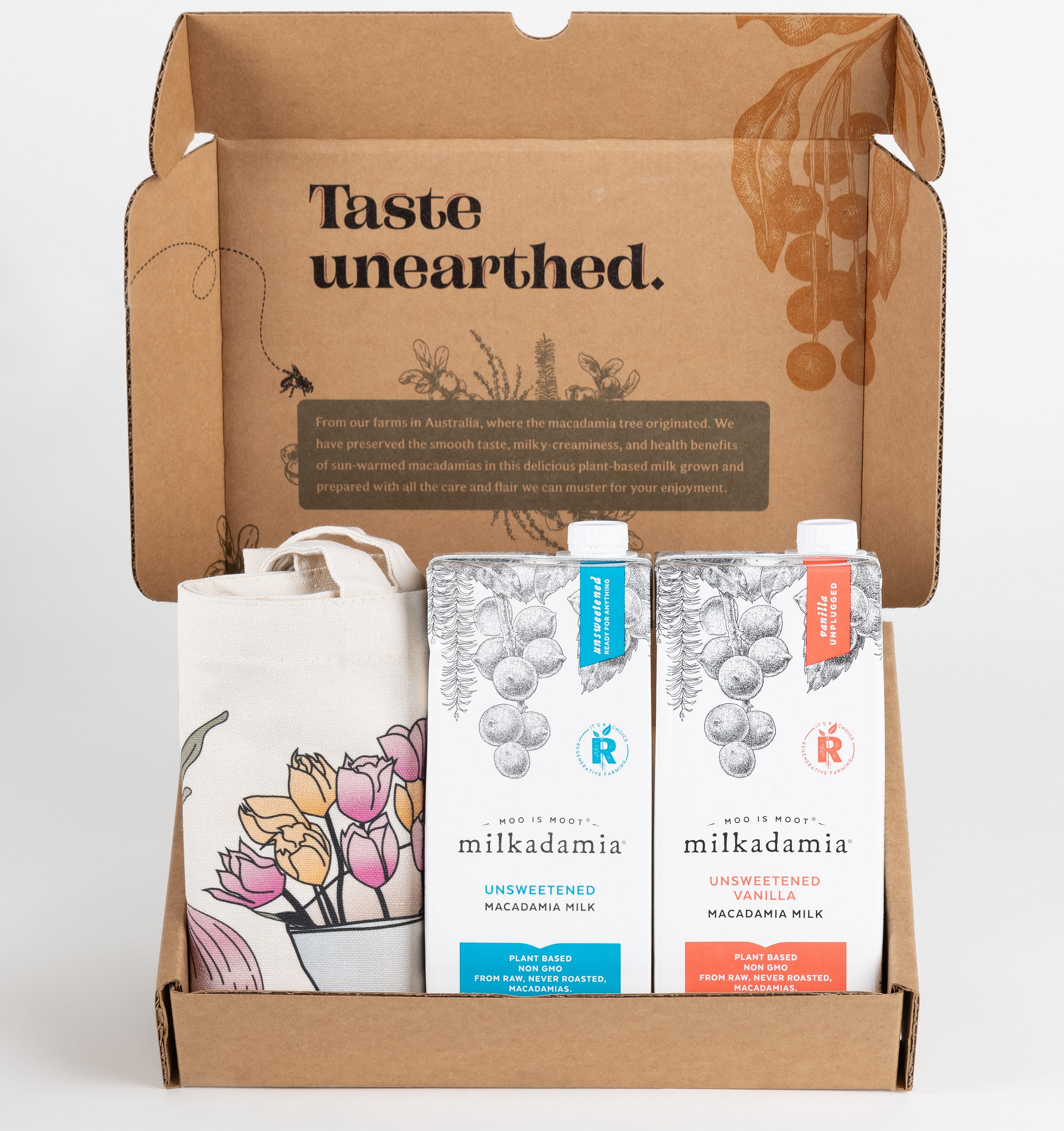 Milkadamia unsweet holiday gift box containing two individual 32 oz cartons of Milkadamia Unsweetened and Unsweetened Vanilla and a signature Milkadamia tote bag